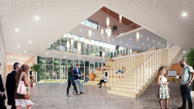 La hall di ingresso e la scalinata multiuso in legno del nuovo istituto scolastico di Biella